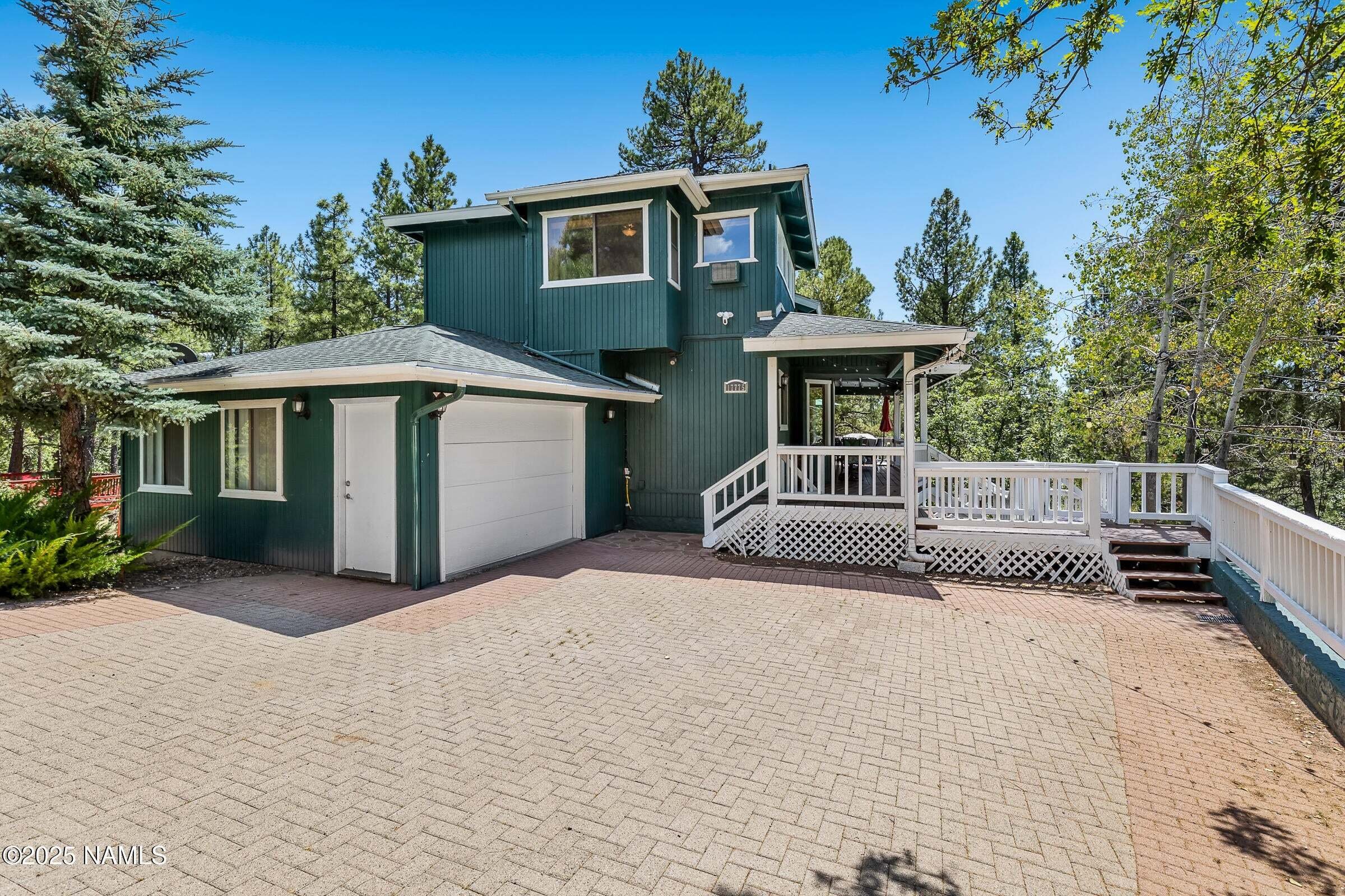 a second story blue house located in Munds Park