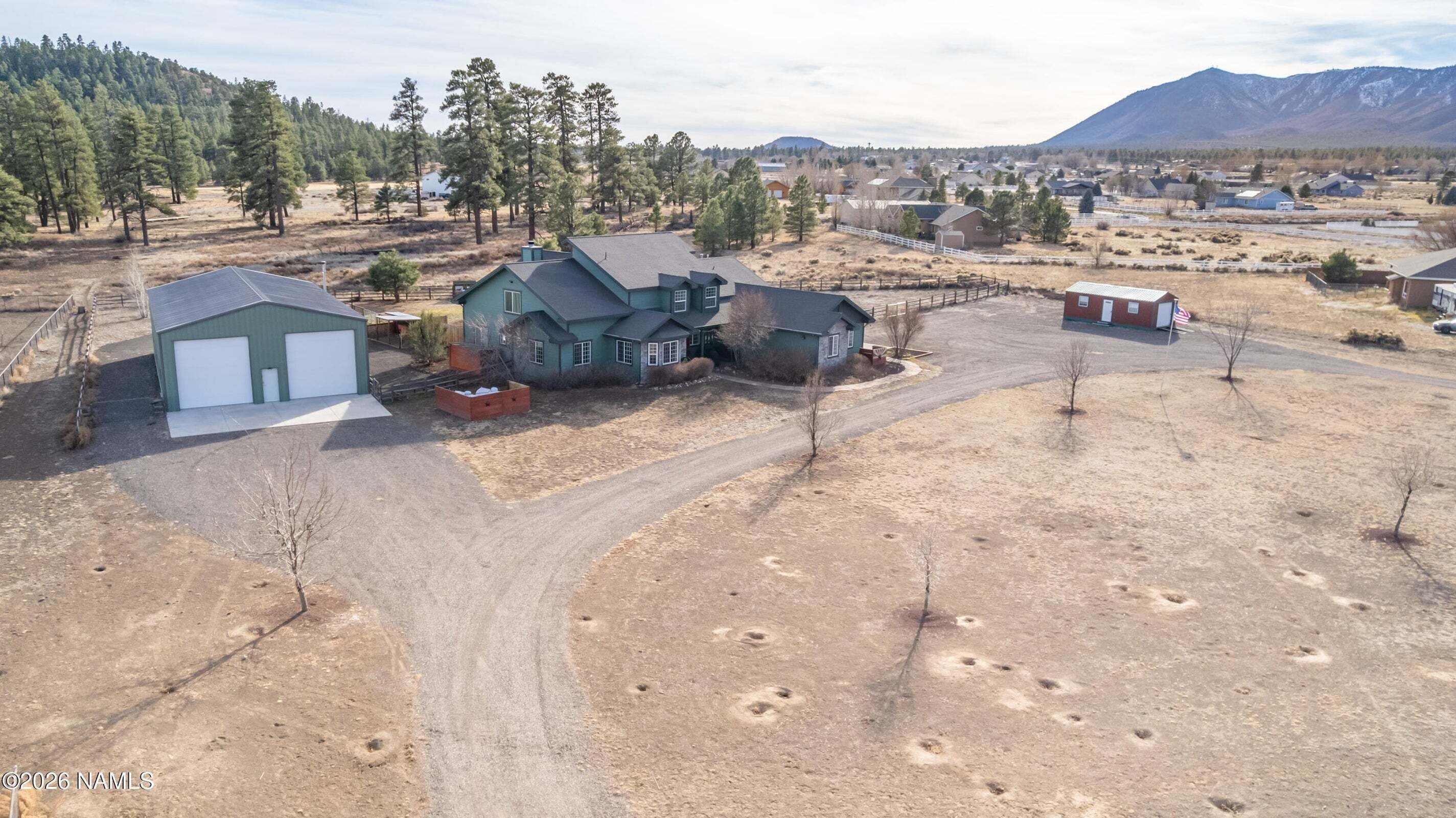 Aerial photo of blue  house with large shop